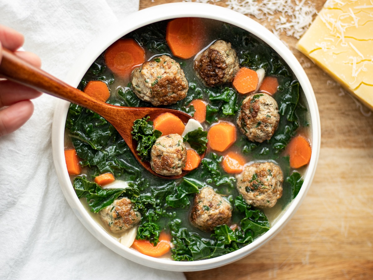  low-carb Italian wedding soup is loaded with mini-meatballs, carrots and green kale floating in a light, delicious broth