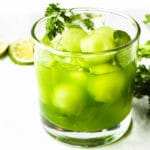 Iced matcha green tea with melon balls in a glass of ice