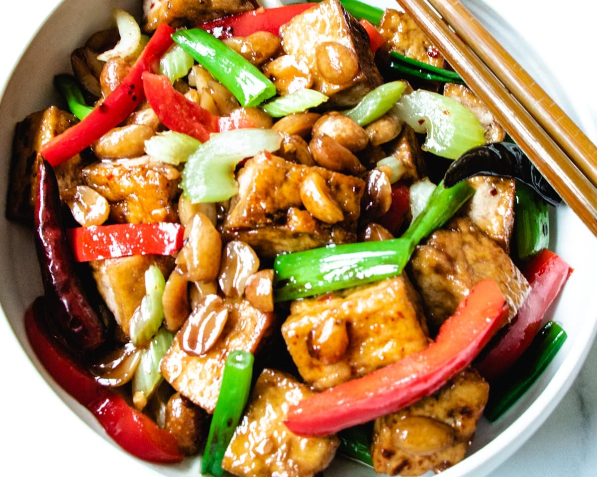 Crispy tofu, toasted peanuts, celery, red bell pepper, chilis and scallions are tossed in a sweet and spicy sauce. This low-carb, vegan dish of stir-fried tofu is inspired by kung pao chicken.