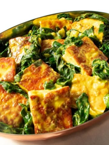 Saag paneer is an Indian dish of leafy greens and fried cheese simmered in savory spices. It's creamed spinach with a big personality. This easy, keto, vegetarian dish is ready in 30 minutes.