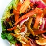 This simple, stylish salad is made of crisp, vibrantly colored watermelon radish, sweet rainbow carrots, juicy blood orange and lettuce. It's a delicious rainbow in a salad.