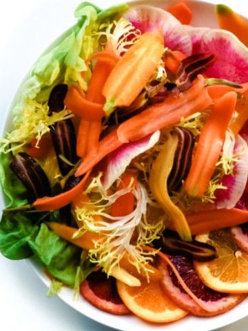 This simple, stylish salad is made of crisp, vibrantly colored watermelon radish, sweet rainbow carrots, juicy blood orange and lettuce. It's a delicious rainbow in a salad.