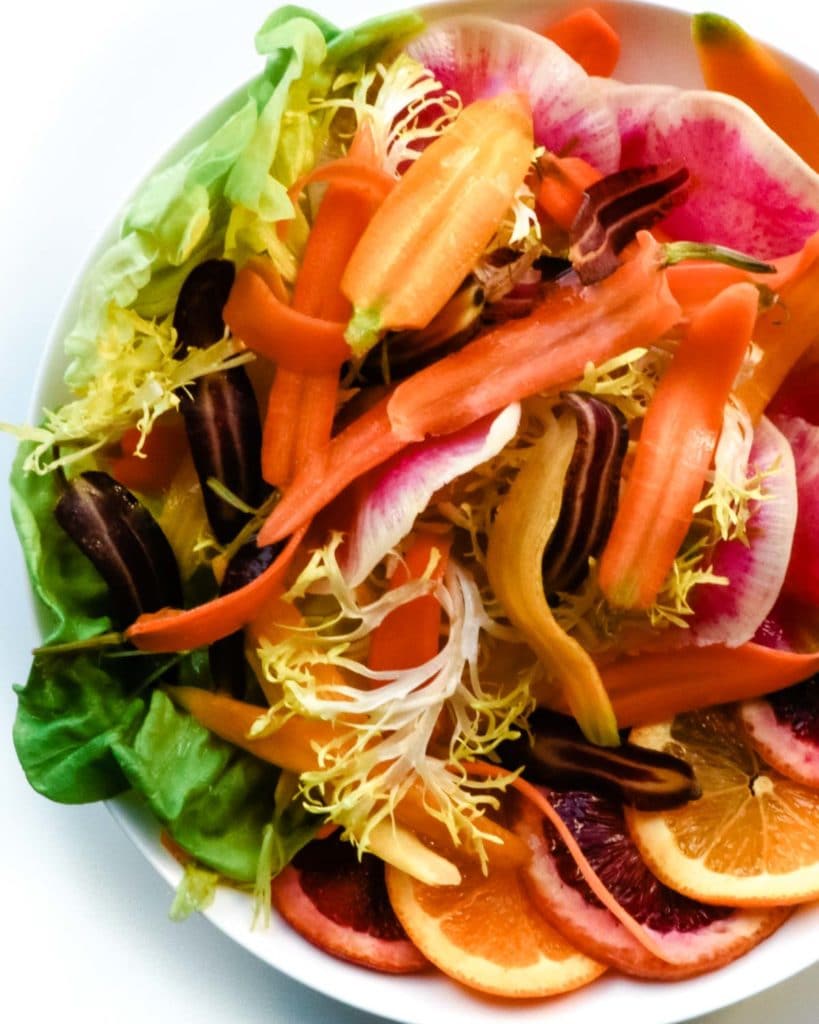 This simple, stylish salad is made of crisp, vibrantly colored watermelon radish, sweet rainbow carrots, juicy blood orange and lettuce. It's a delicious rainbow in a salad.