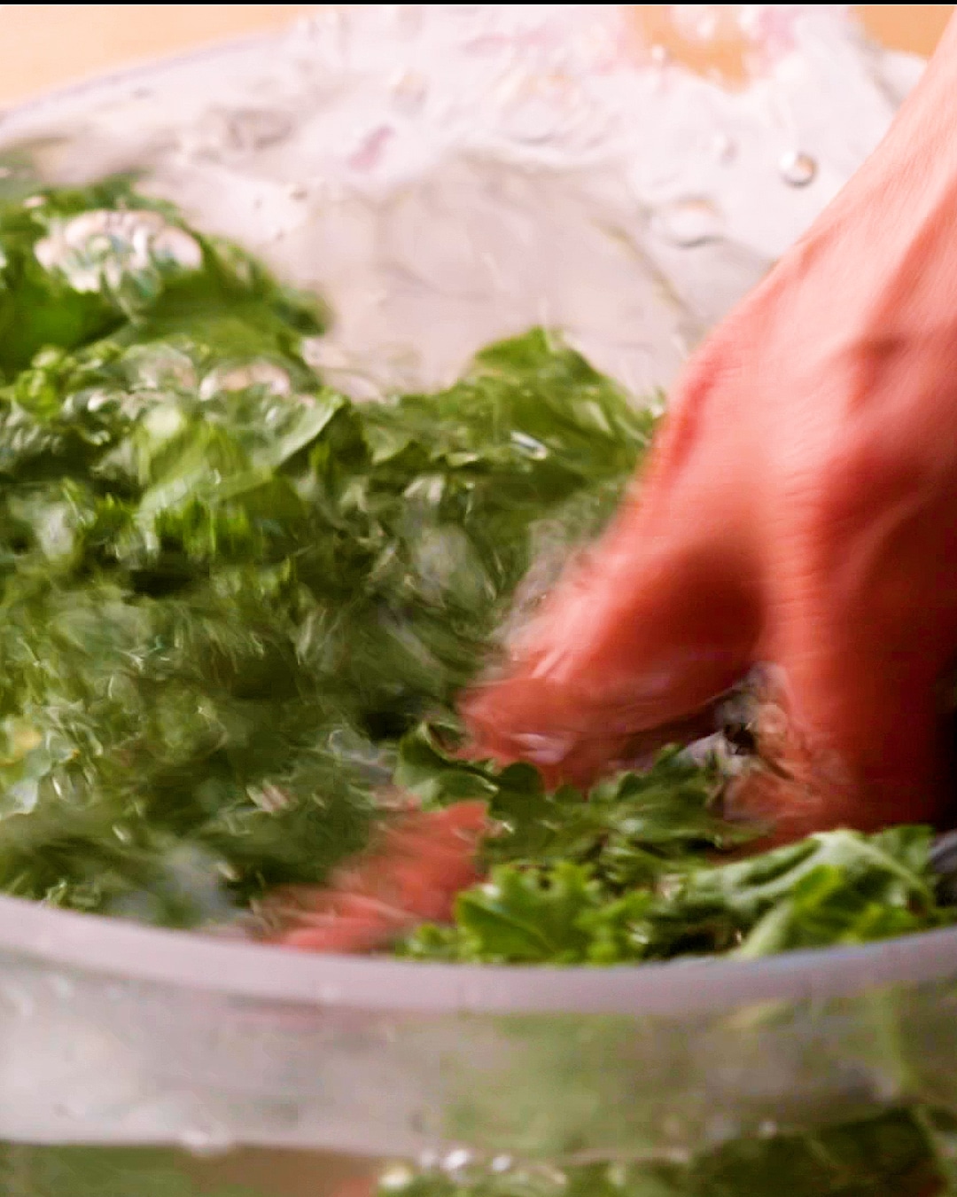 Giving kale leaves a good rinse in a bowl of water