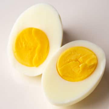 Two hard-boiled egg halves displaying yolks