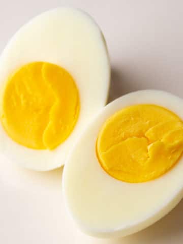 Two hard-boiled egg halves displaying yolks