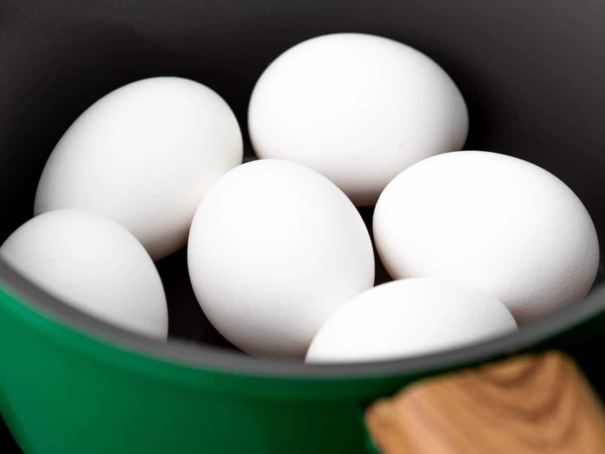 6 large white eggs in a medium pot
