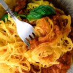 Air fryer spaghetti squash noodles with pasta sauce and fresh basil