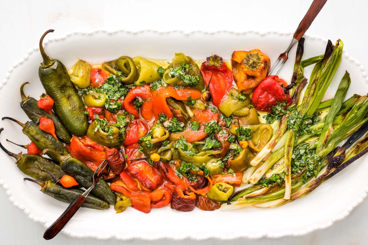 Roasted mixed peppers on a platter with a parsley lemon vinaigrette