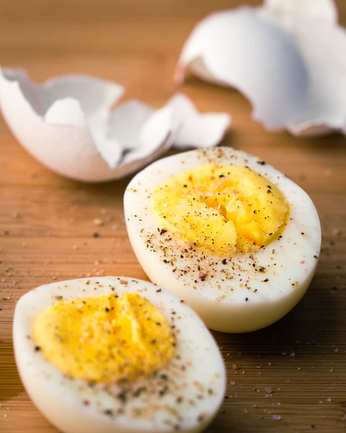Steamed hard boiled eggs sliced in half with salt and pepper