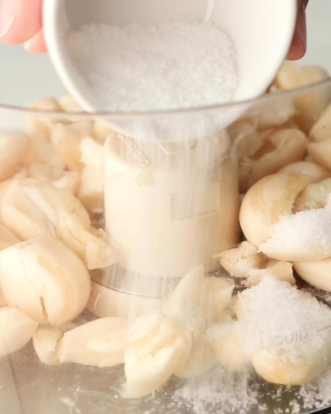 Toum Process Step 1 - Add garlic and salt to a food processor