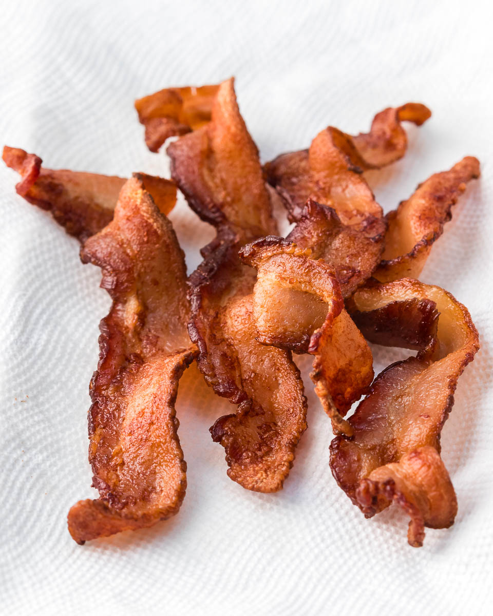 Air fryer bacon side view of cooked bacon on paper towel