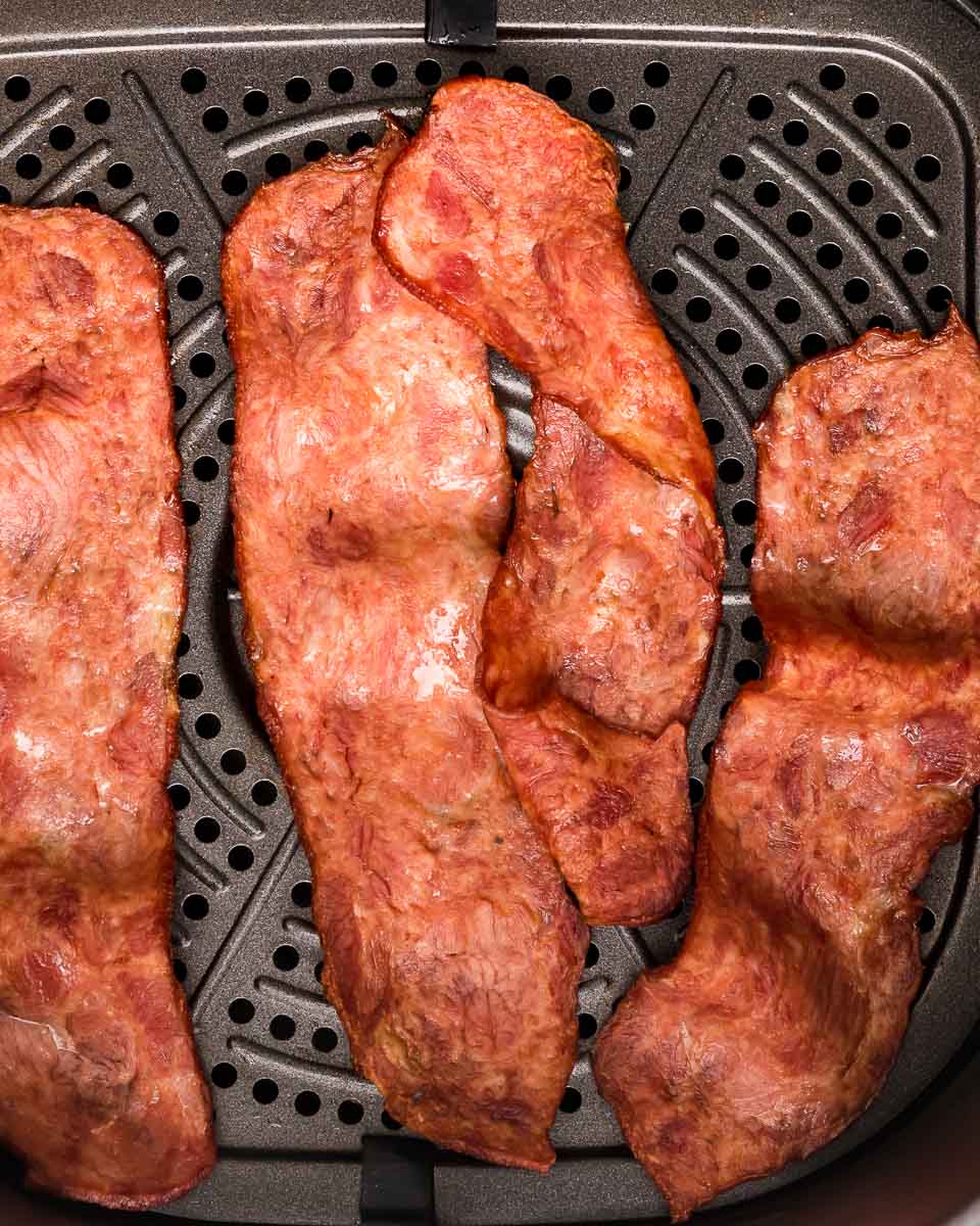 Air fryer turkey bacon cooked in air fryer basket
