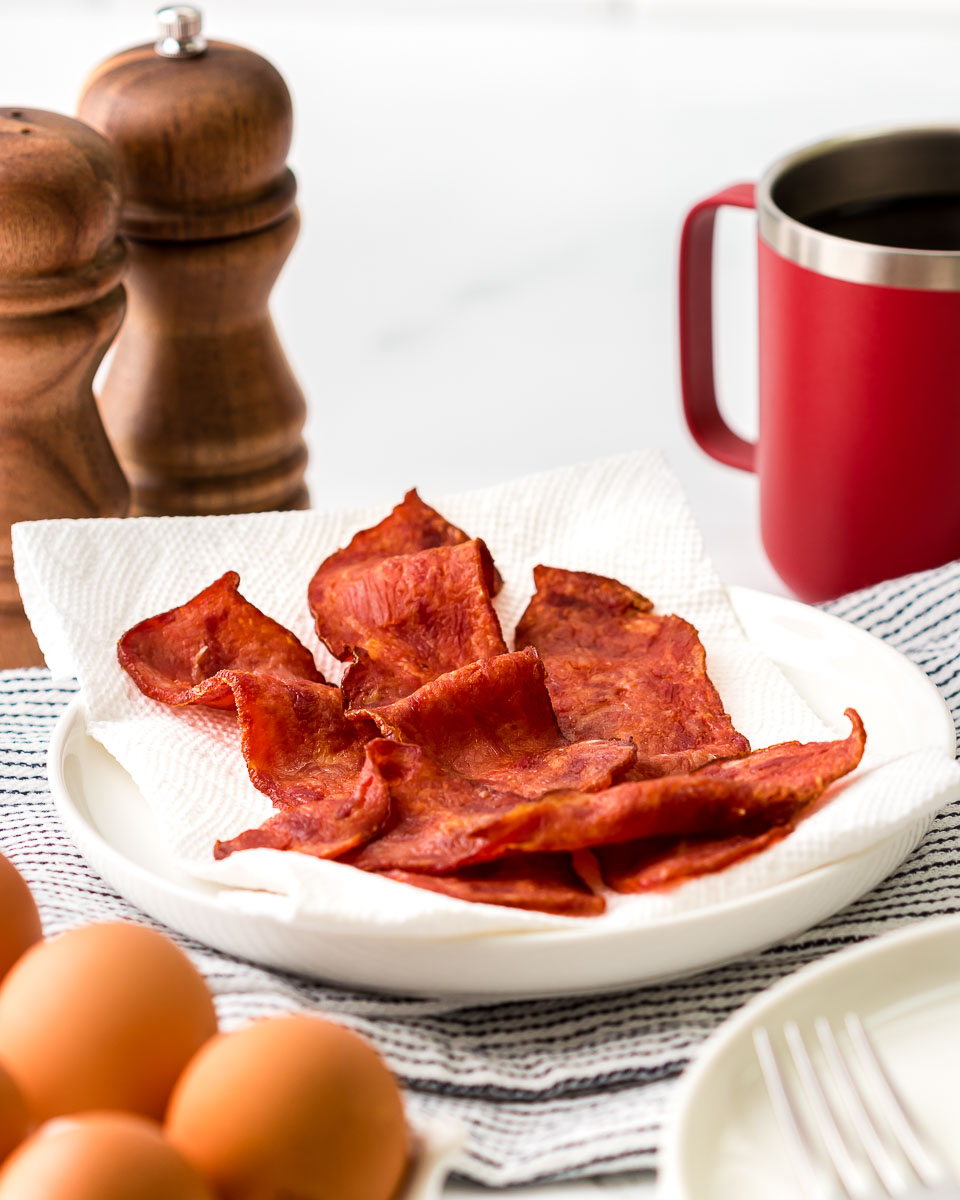 Air fryer turkey bacon served with coffee and eggs side view