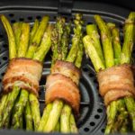 air fryer bacon wrapped asparagus in air fryer basket featured image