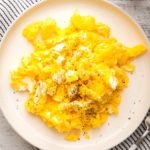 air fryer scrambled eggs on a round white plate