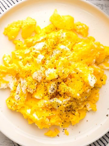 air fryer scrambled eggs on a round white plate
