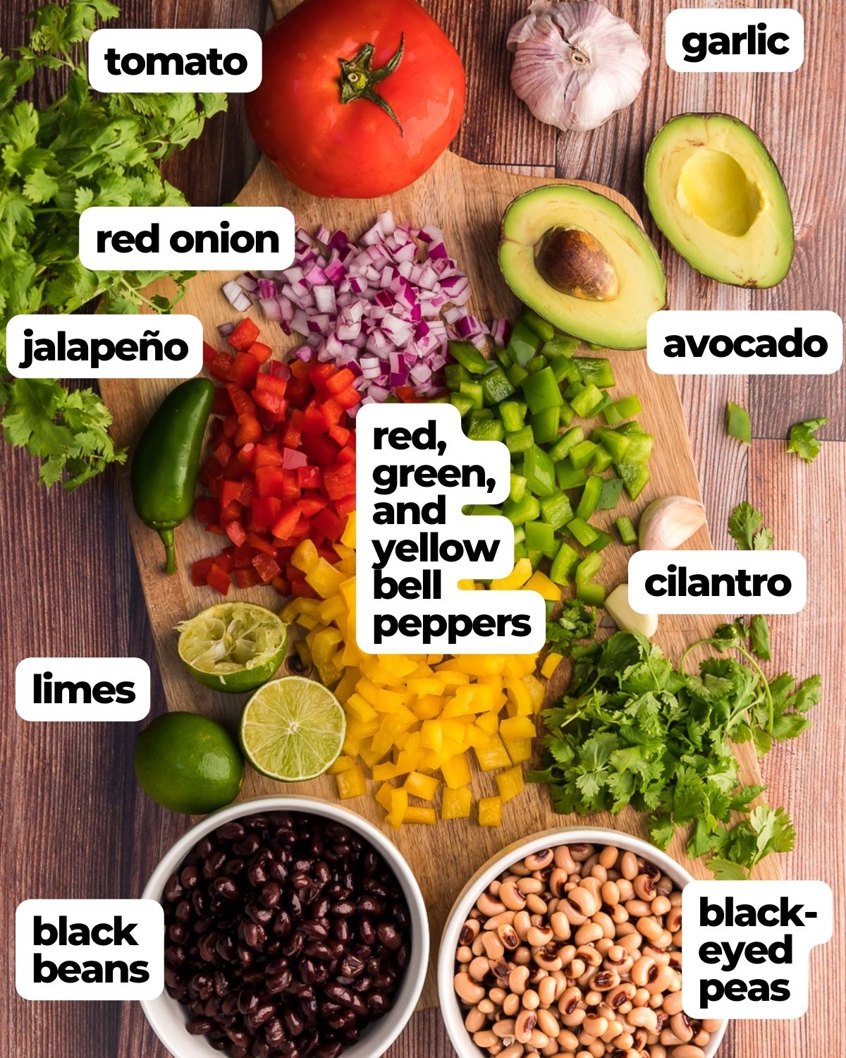 cowboy caviar ingredients labeled tomato, garlic, red onion, avocado, jalapeno, bell peppers, cilantro, lime juice, black-eyed peas, black beans