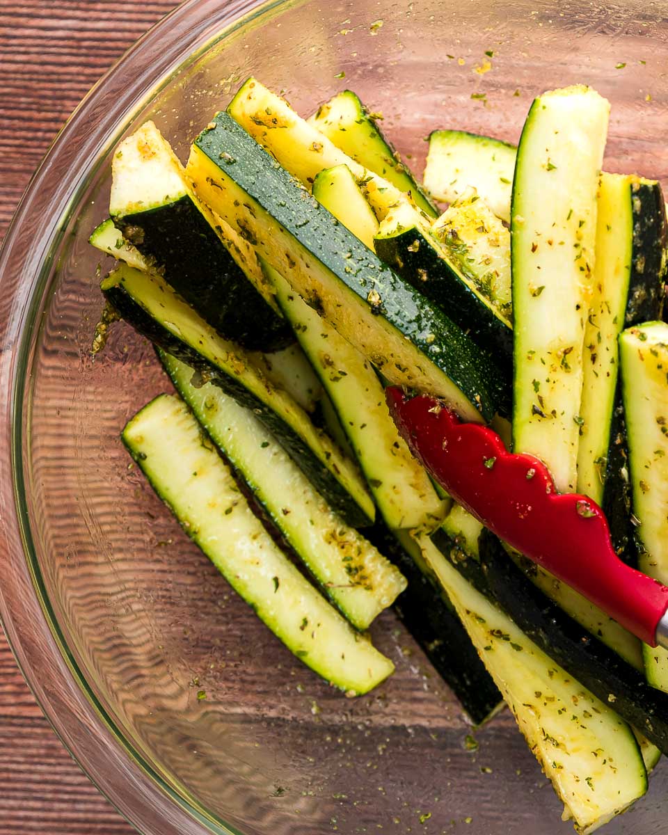 Air fryer zucchini fries step 2 toss with seasoning