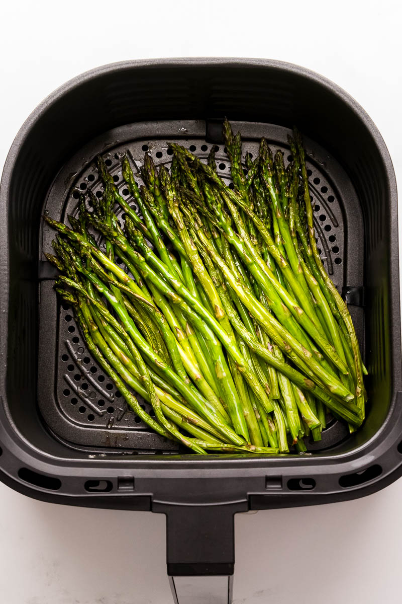 Air fryer asparagus cooked in air fryer basket