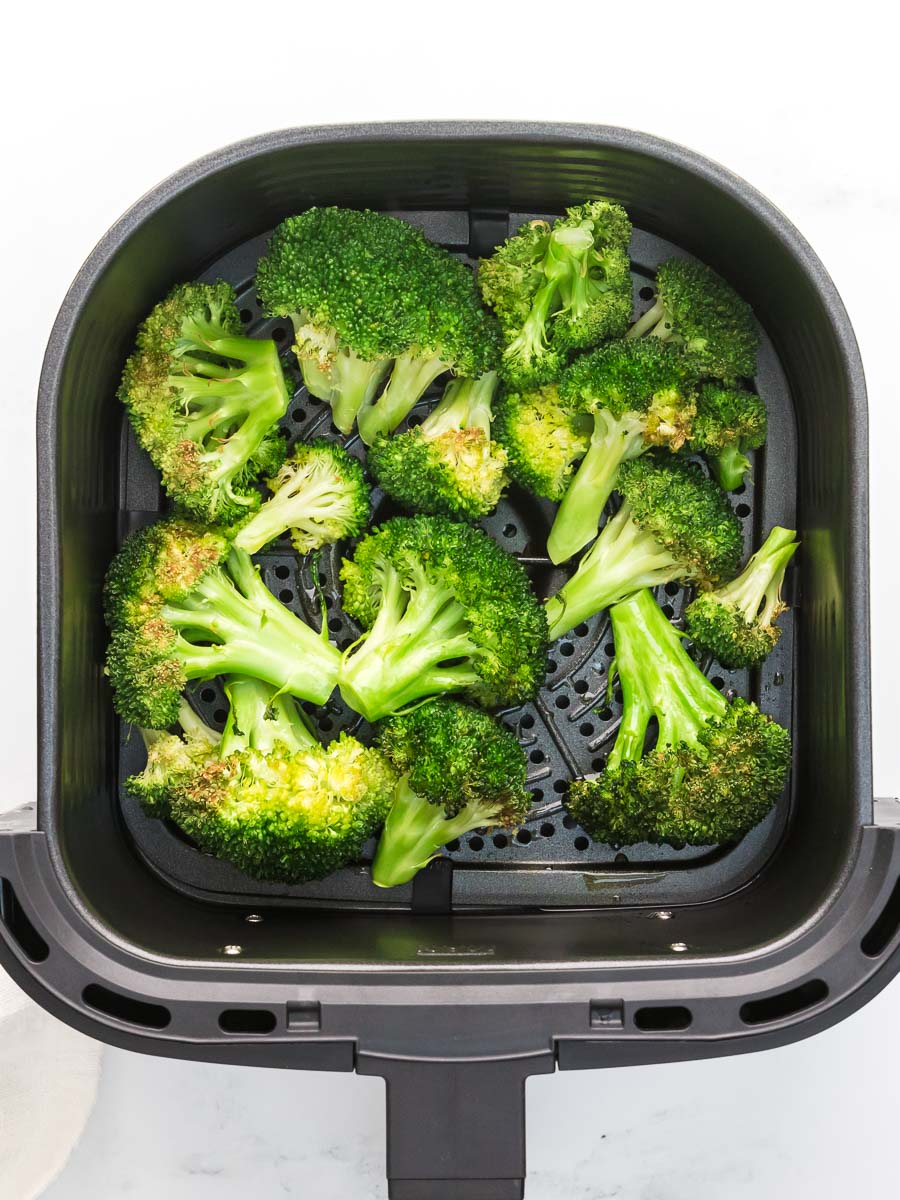 Cooked air fryer broccoli in air fryer basket