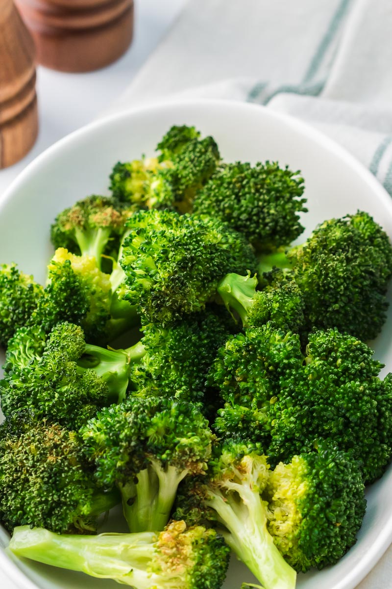 Air fryer broccoli served on a platter tall image