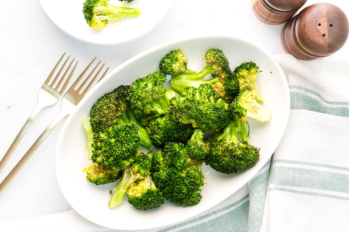 Air fryer broccoli served table setting wide image