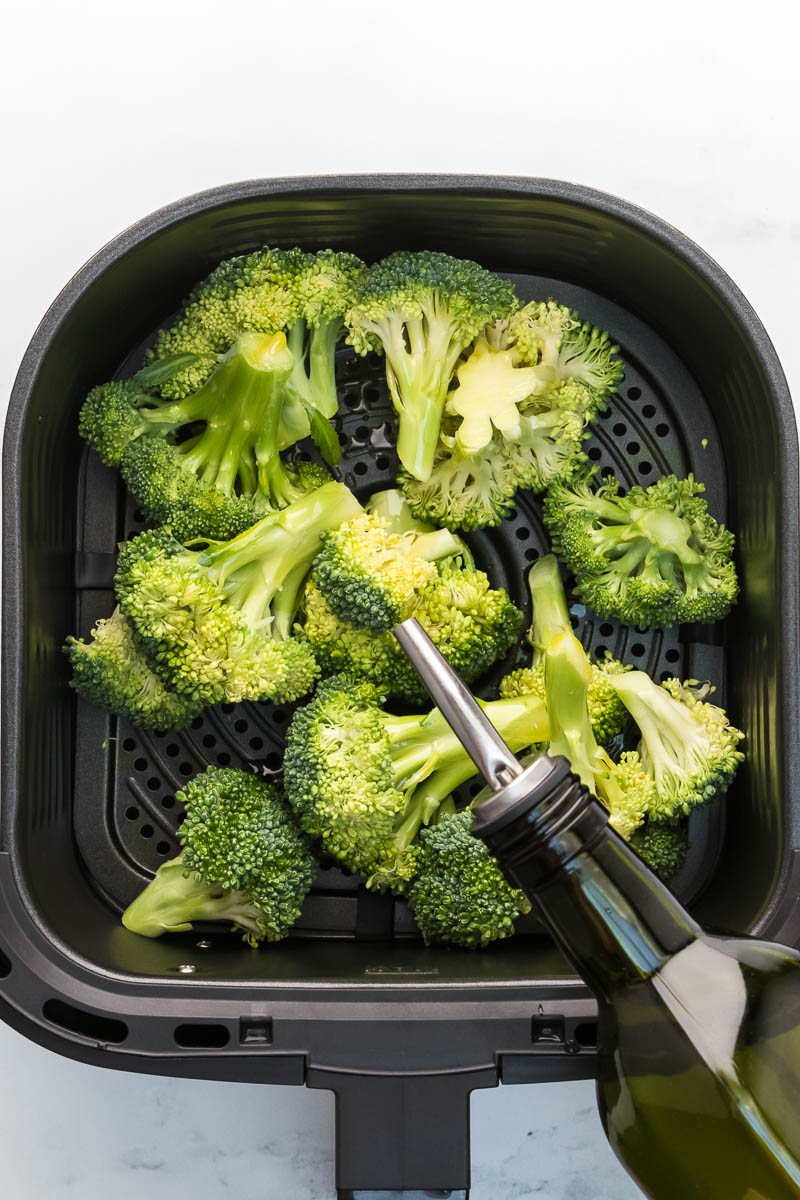 Air fryer broccoli step 1 coat in oil