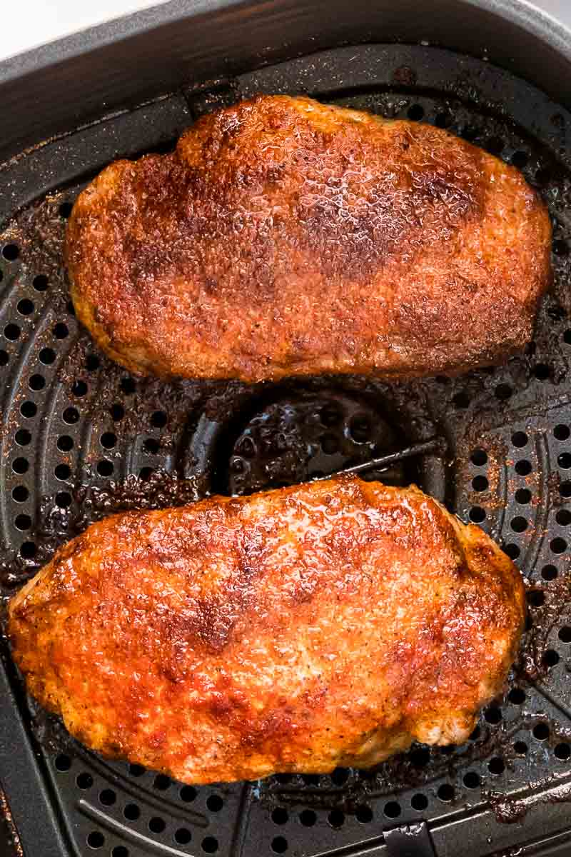 Air fryer pork chops cooked in air fryer basket extra closeup