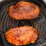 Air fryer pork chops cooked in air fryer basket square overhead