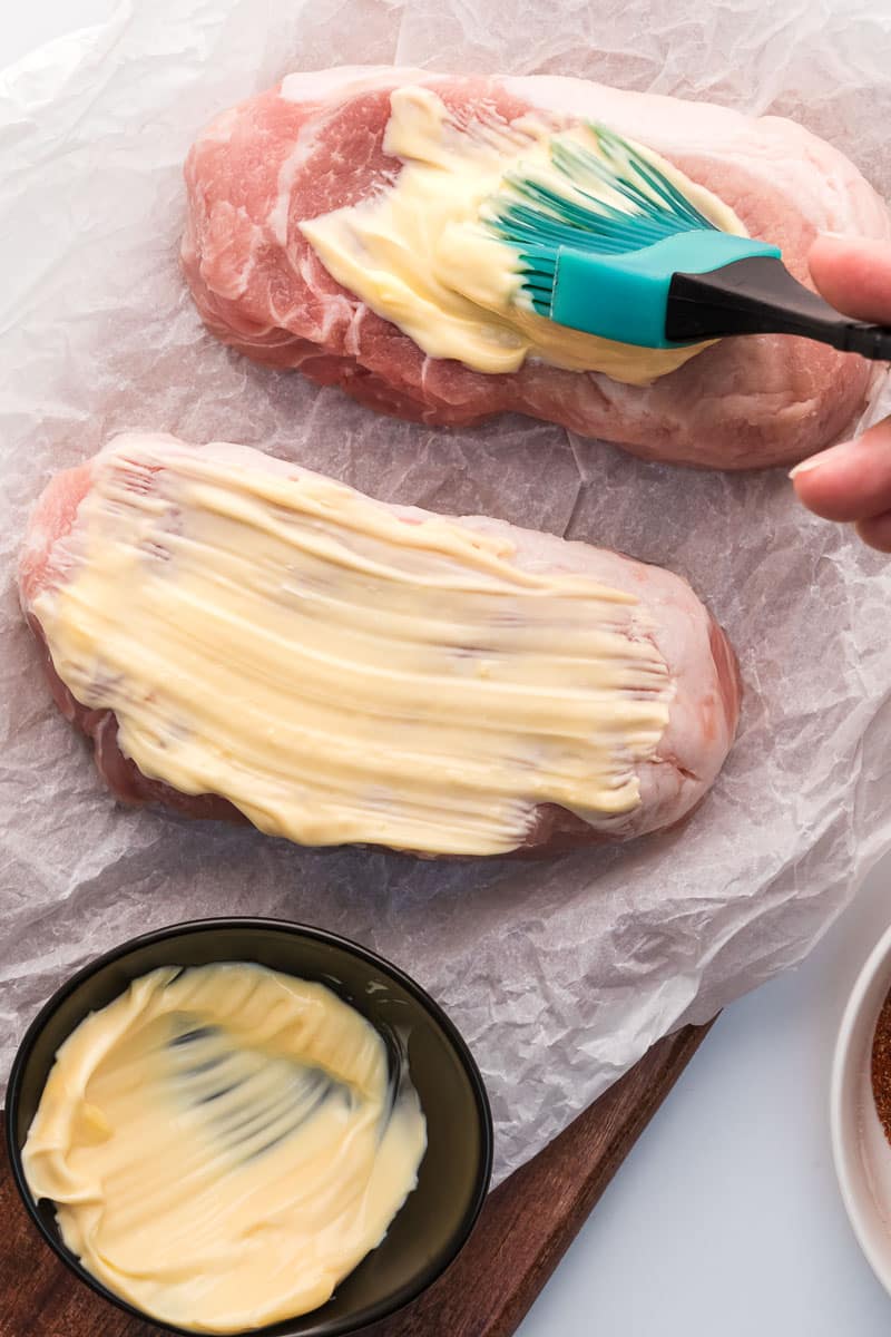 Air fryer pork chops step 2 coat in mayonnaise