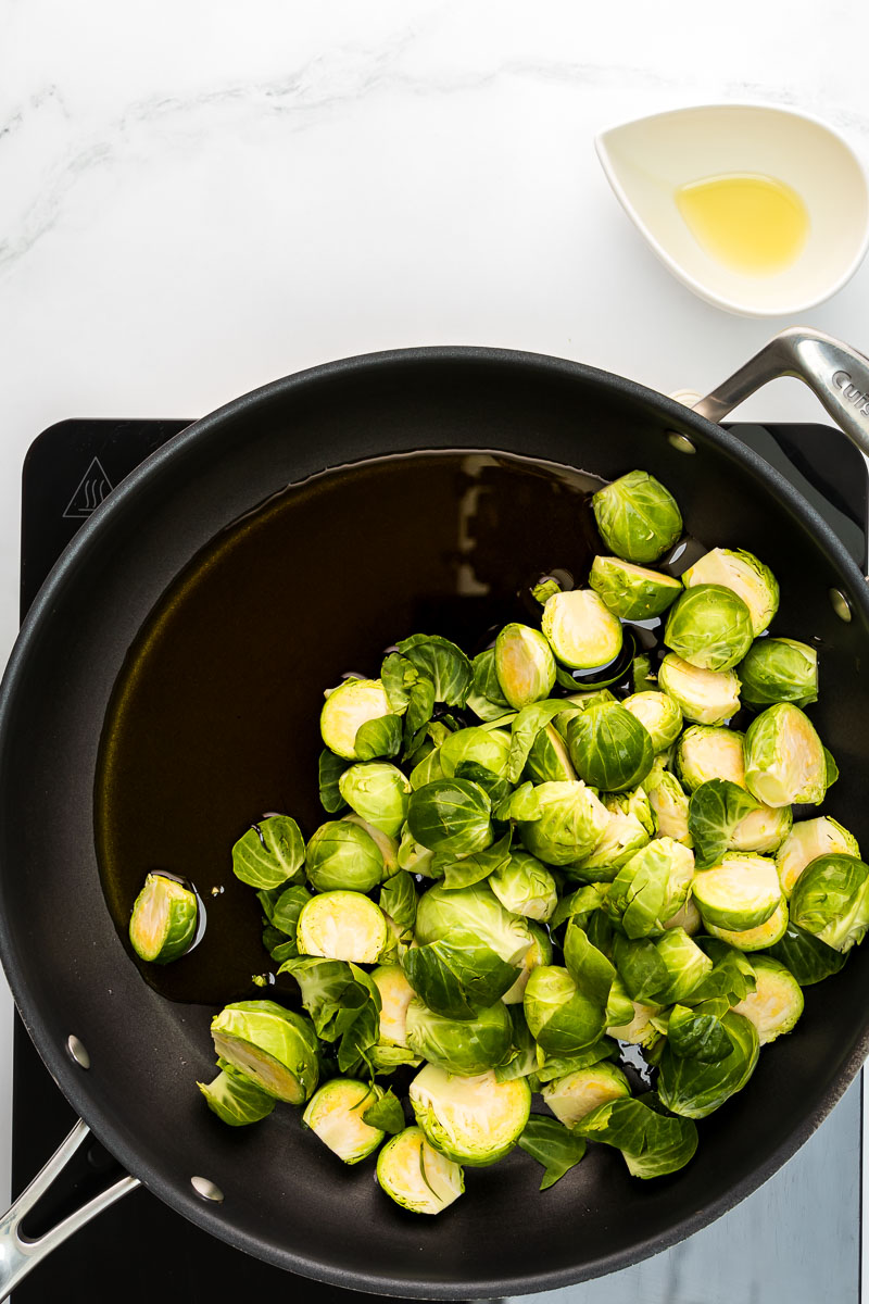 Balsamic glazed Brussels sprouts step 2 Brussels sprouts in pan with olive oil