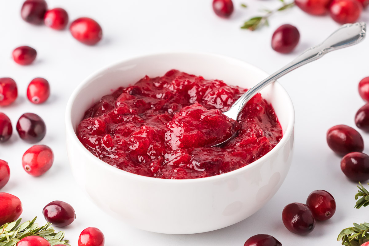 Keto Cranberry Sauce in bowl on a spoon wide shot