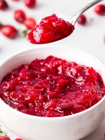 Keto Cranberry Sauce featured image with spoon for web story poster